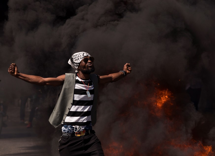 epa09013150 A person participates in a demonstration against the Government of Jovenel Moise, in Port-au-Prince, Haiti, 14 February 2021. A new political crisis erupted in Haiti last week after the re ...