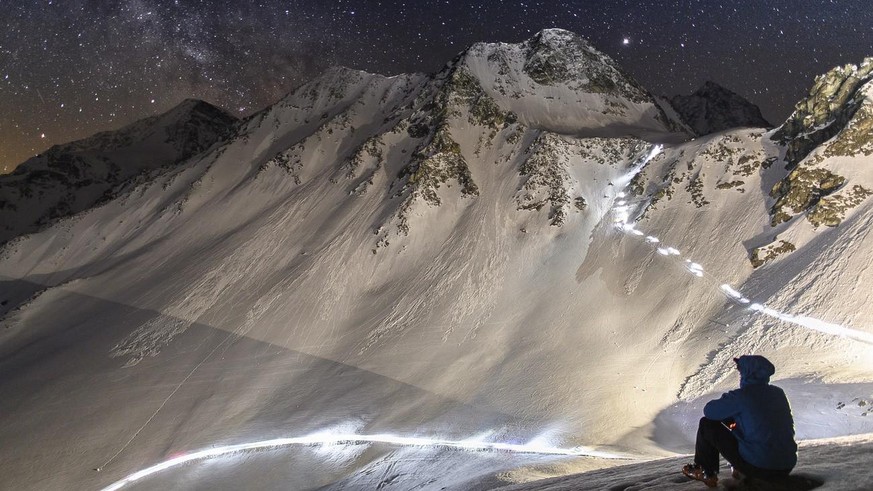 Competitors climb on their way to the &quot;Col De Riedmatten&quot; pass and &quot;Col De Tsena Refien&quot; pass under the milky way, during the 21st Glacier Patrol race near Arolla, Switzerland, thi ...