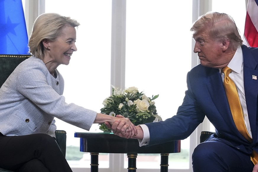 President Donald Trump and European Commission President Ursula von der Leyen shake hands after reaching a trade deal at the Trump Turnberry golf course in Turnberry, Scotland Sunday, July 27, 2025. ( ...
