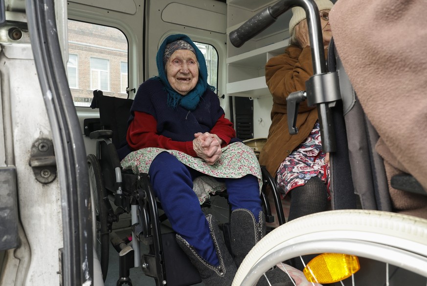 epa11335898 An elderly woman on a wheelchair in a bus as they are evacuated from territories bordering Russia, on the outskirts of Vovchansk, Kharkiv region, northeastern Ukraine, 12 May 2024, amid th ...