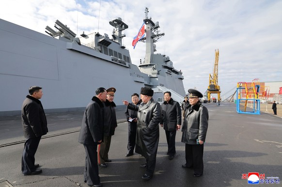 In this photo provided by the North Korean government, its leader Kim Jong Un, center, inspects new destroyer, Choe Hyon ahead of its commissioning at a shipyard in Nampo, North Korea Tuesday, March 3 ...