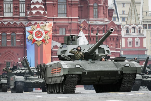 FILE - A Russian Armata tank, foreground rolls along Red Square during a rehearsal for the Victory Day military parade in Moscow, Russia, Sunday, May 6, 2018. An independent Sweden-based watchdog says ...