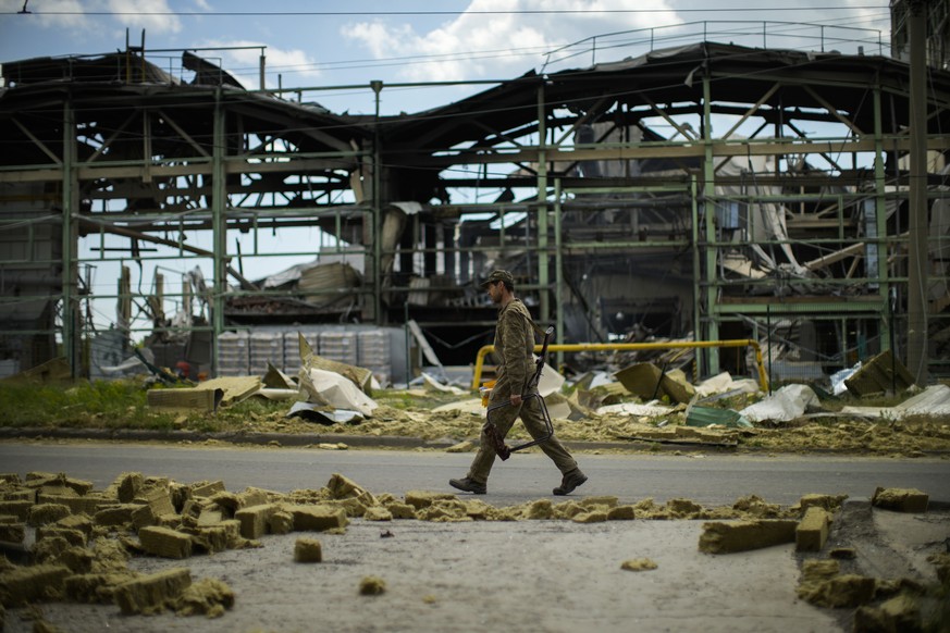 A Ukrainian serviceman walks past a gypsum manufacturing plant destroyed in a Russian bombing in Bakhmut, eastern Ukraine, eastern Ukraine, Saturday, May 28, 2022. Fighting has raged around Lysychansk ...