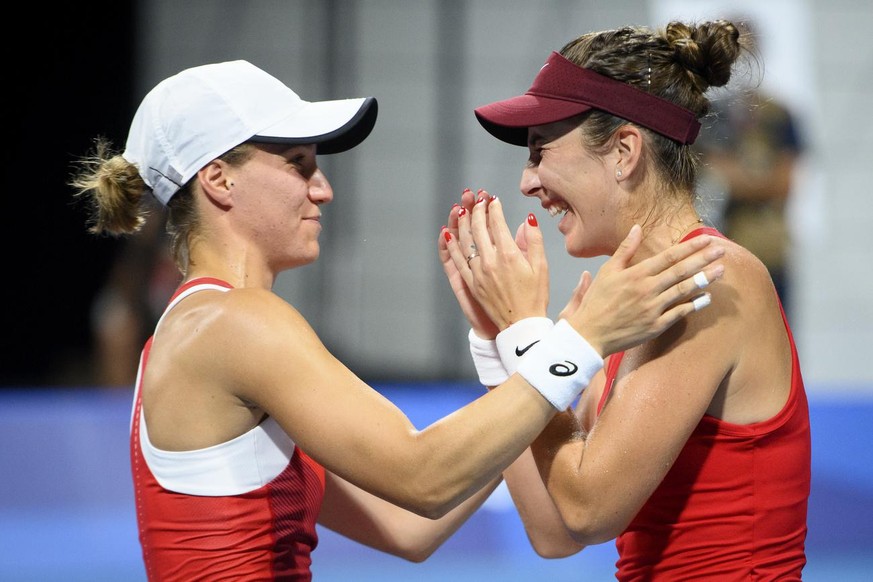 Belinda Bencic, right, and Viktorija Golubic, left, of Switzerland celebrate after winning against Laura Pigossi and Luisa Stefani of Brazil during the women&#039;s doubles tennis semifinal at the 202 ...