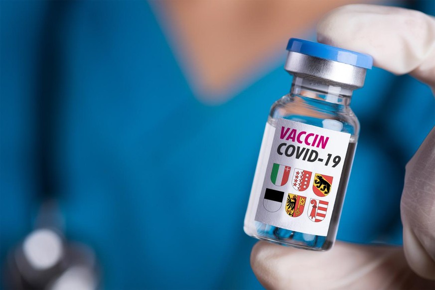 Female doctor with a stethoscope on shoulder holding syringe and COVID-19 vaccine. Healthcare And Medical concept.