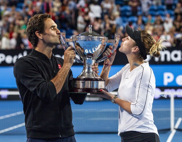 epa07264149 Roger Federer and Belinda Bencic of Switzerland hold up the Hopman Cup after winning the mixed doubles match between Switzerland and Germany on day 8 of the Hopman Cup tennis tournament at ...