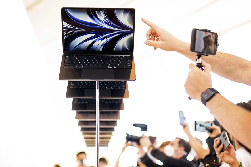 The new Apple MacBook Air with the M2 processor is displayed as visitors take photos of it, Monday, June 6, 2022, following the keynote presentation of Apple&#039;s World Wide Developer Conference on  ...