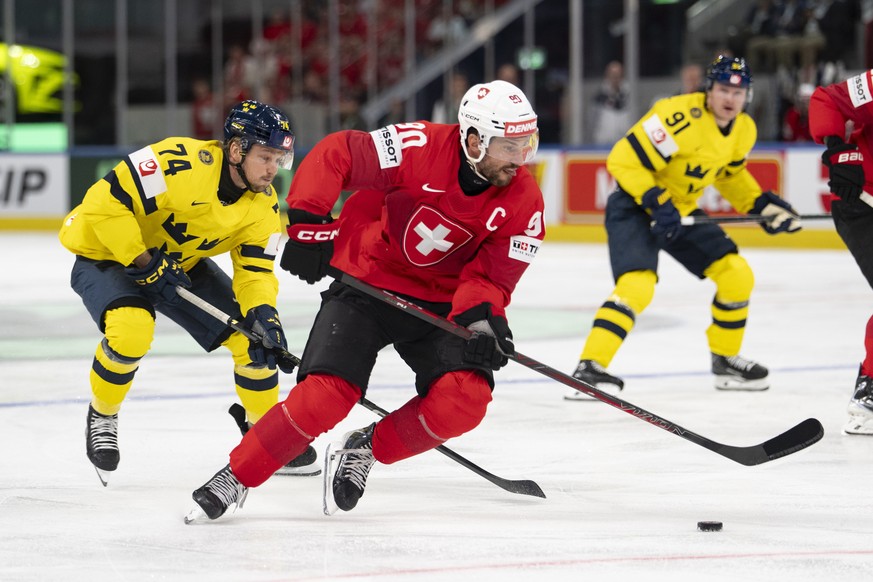 epa13001139 Switzerland's Roman Josi (R) in action against Sweden's Rasmus Asplund (L) during the 2026 IIHF Men's Ice Hockey World Championship Quarterfinal game between Switzerland and ...