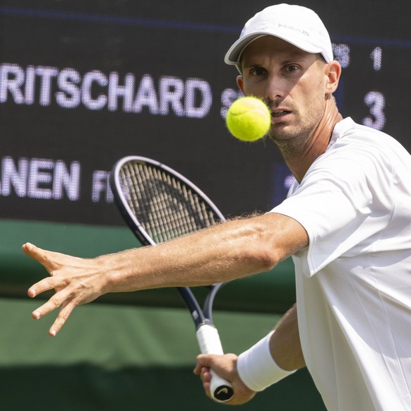 Alexander Ritschard of Switzerland returns the ball to Otto Virtanen of Finland in their second round match of the Qualifying competition for the All England Lawn Tennis Championships in Roehampton, L ...