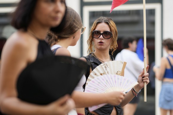 Demonstrators use fans to help with the high temperature during a protest against the housing crisis affecting Portugal, in Lisbon, Saturday, June 28, 2025. (AP Photo/Armando Franca)
Portugal Housing  ...