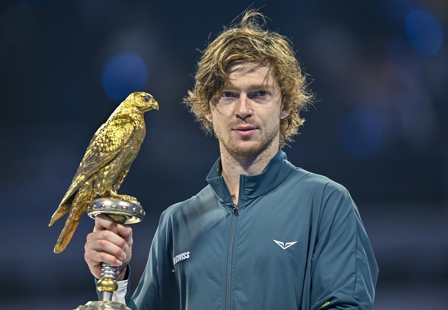 epa11916399 Andrey Rublev of Russia poses with the trophy after winning the final against Jack Draper of Britain at the Qatar Open tennis tournament in Doha, Qatar, 22 February 2025. EPA/NOUSHAD THEKK ...