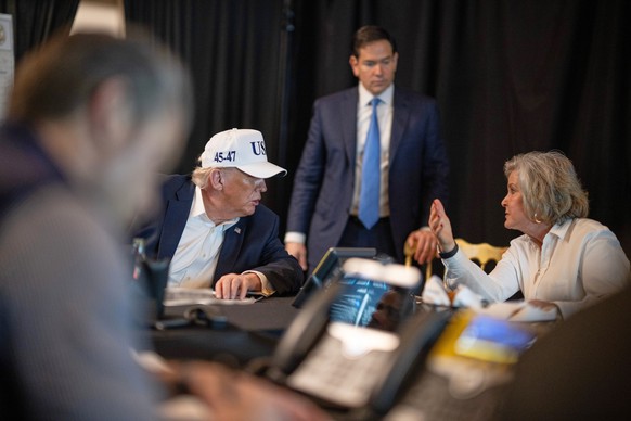 This photo provided by the White House which has been partially blurred, shows President Donald Trump talking with White House chief of staff Susie Wiles as Secretary of State Marco Rubio listens at M ...