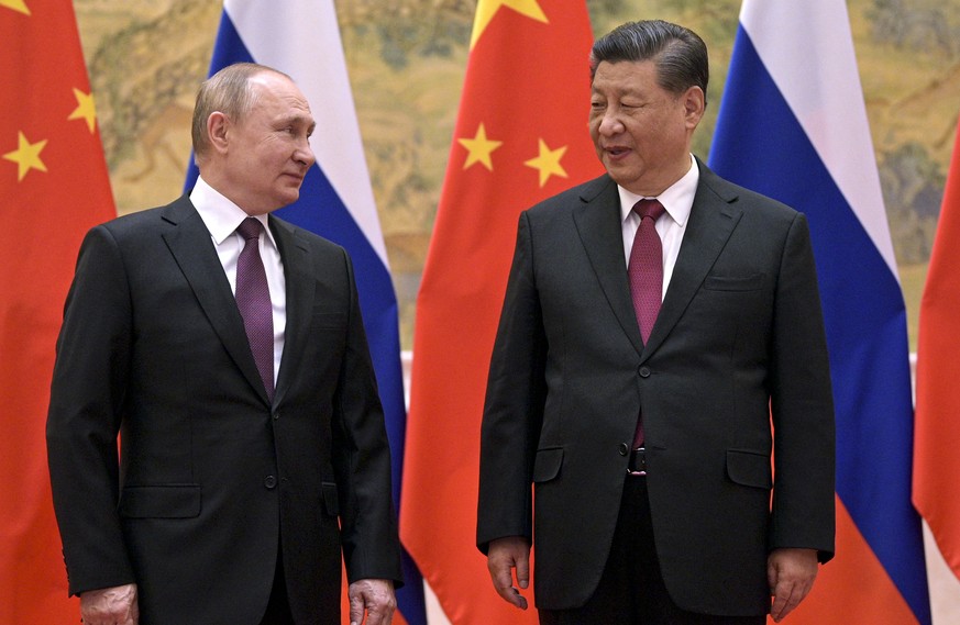 FILE - Chinese President Xi Jinping, right, and Russian President Vladimir Putin talk to each other during their meeting in Beijing, Friday, Feb. 4, 2022. The two leaders used the occasion of the Wint ...