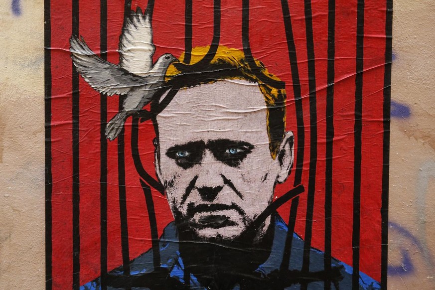 epa08963958 A view of a large poster depicting Russian opposition leader Alexei Navalny behind bars with a dove freeing him from detention, by an unidentified street artist known as Harry Greb, in dow ...