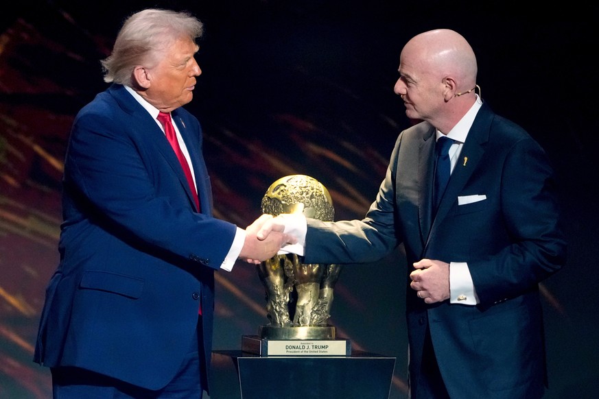 FILE - FIFA President Gianni Infantino, right, awards President Donald Trump with the FIFA Peace Prize during the draw for the 2026 soccer World Cup at the Kennedy Center in Washington, Dec. 5, 2025.  ...