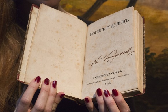 London, UK. 27 November 2015. A Christie s employee presents the 1831 first edition of Alexander Pushkin s Boris Godunov, estimate GBP 40,000-60,000, from the collection of Sergei Gessen. Christie s L ...