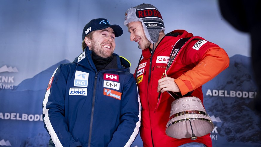 Second placed Aleksander Aamodt Kilde of Norway, left, and Winner Marco Odermatt of Switzerland, celebrate with cowbells during the ceremony of the men&#039;s giant slalom race at the Alpine Skiing FI ...