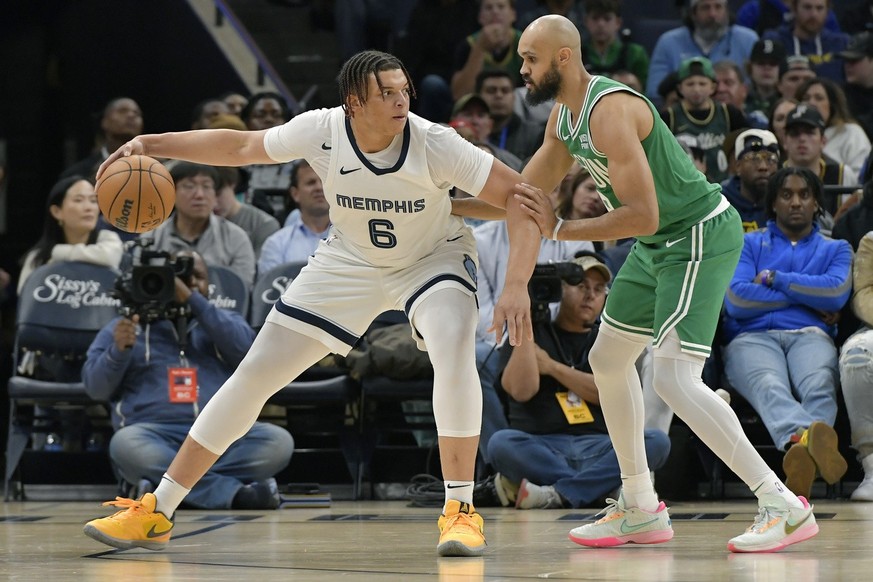 Memphis Grizzlies forward Kenneth Lofton Jr. (6) handles the ball against Boston Celtics guard Derrick White (9) in the second half of an NBA basketball game Sunday, Nov. 19, 2023, in Memphis, Tenn. ( ...