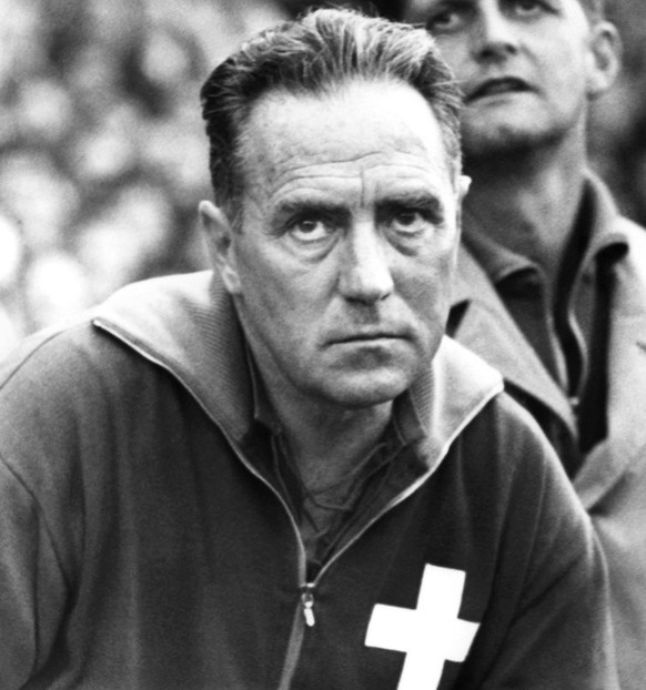 Alfredo Foni (1911-1985), links, Coach der Schweizer Fussballnationalmannschaft, beobachtet ein Spiel am 11. November 1964 mit ernster Miene. Neben ihm Roger Quinche und Pfleger Hari. Foni trainierte ...