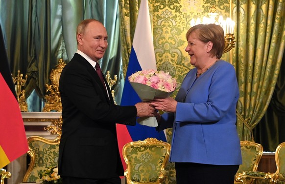 epaselect epa09421878 Russian President Vladimir Putin (L) and German Chancellor Angela Merkel (R) during their meeting in the Kremlin in Moscow, Russia, 20 August 2021. German Chancellor is on a work ...