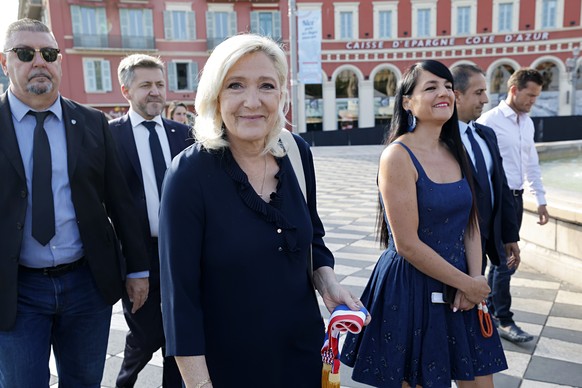 epa13110118 Rassemblement National (RN) parliamentary party leader Marine Le Pen (C-L) and UDR's MP Christelle D'Intorni (C-R) arrive at the annual Bastille Day military parade in Nice, Fran ...