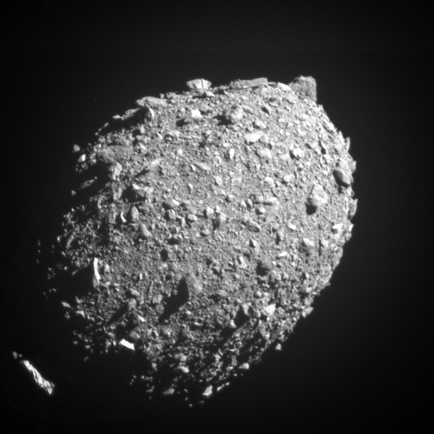 epa10236856 A handout picture made available by the National Aeronautics and Space Administration (NASA) on 11 October 2022 of asteroid moonlet Dimorphos as seen by the DART spacecraft 11 seconds befo ...