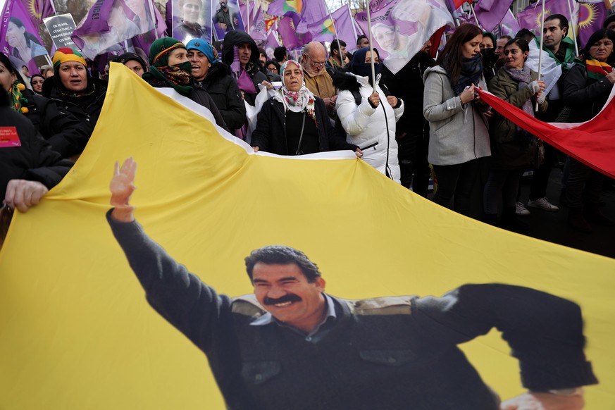 Kurdish activists hold a banne of jailed PKK leader Abdullah Ocalan during a protest in Paris, Saturday, Jan. 7, 2023. Kurdish groups from around France and Europe are marching in Paris to show their  ...