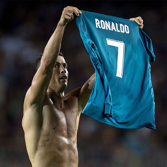 Real Madrid&#039;s Portuguese forward Cristiano Ronaldo takes off his jersey to celebrate his goal during the first leg of the Spanish Supercup football match between FC Barcelona and Real Madrid CF a ...