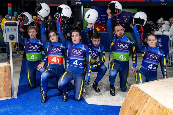 CORTINA D'AMPEZZO, ITALY - FEBRUARY 12: Ihor Hoi, Nazarii Kachmar, Yulianna Tunytska, Olena Stetskiv, Oleksandra Mokh and Andriy Mandziy of Team Ukraine reacts in the finish after the Luge Team R ...