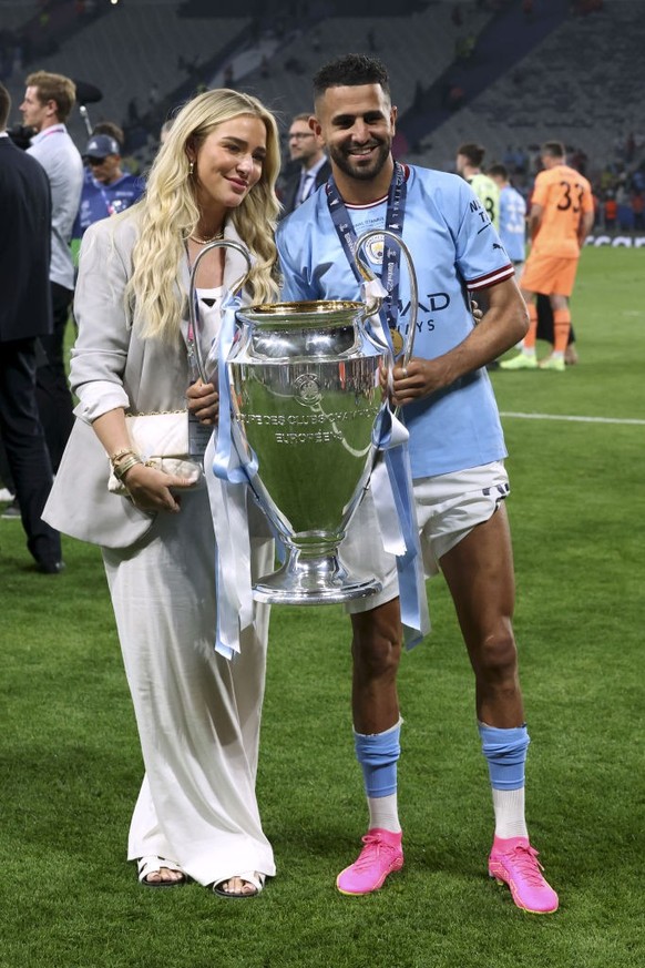 ISTANBUL, TURKEY - JUNE 10: Riyad Mahrez of Manchester City and Taylor Ward celebrate with the UEFA Champions League trophy after the team's victory in the UEFA Champions League 2022/23 final mat ...