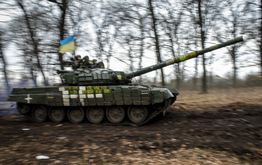 epa10413475 A Ukrainian T-72 tank manoeuvers through the trees in the Donetsk region, eastern Ukraine, 18 January 2023. Britain?s defence secretary Ben Wallace confirmed on Monday that the UK would se ...