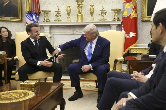 France's President Emmanuel Macron, from left, speaks with President Donald Trump as Secretary of State Marco Rubio listens during a meeting in the Oval Office of the White House in Washington, M ...