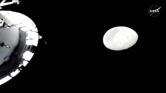 In this image from video provided by NASA, the Moon is seen from a camera outside the Orion Spacecraft as the Artemis II astronauts acknowledge the Apollo 13 astronauts as the crew and spacecraft surp ...