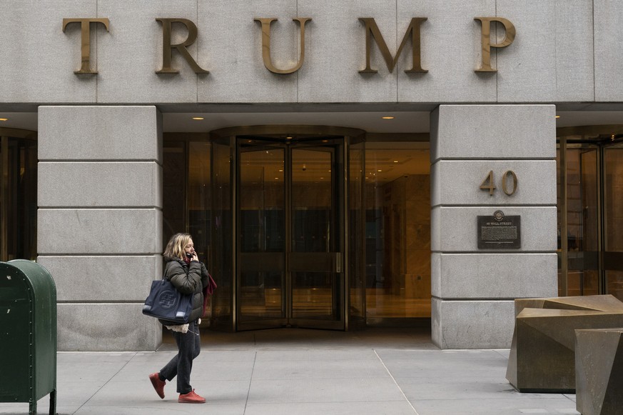 FILE - A woman walks past the Trump Building in New York&#039;s financial district, Wednesday, Jan. 13, 2021. Mazars USA LLP, the accounting firm that prepared former President Donald Trump���s annual ...