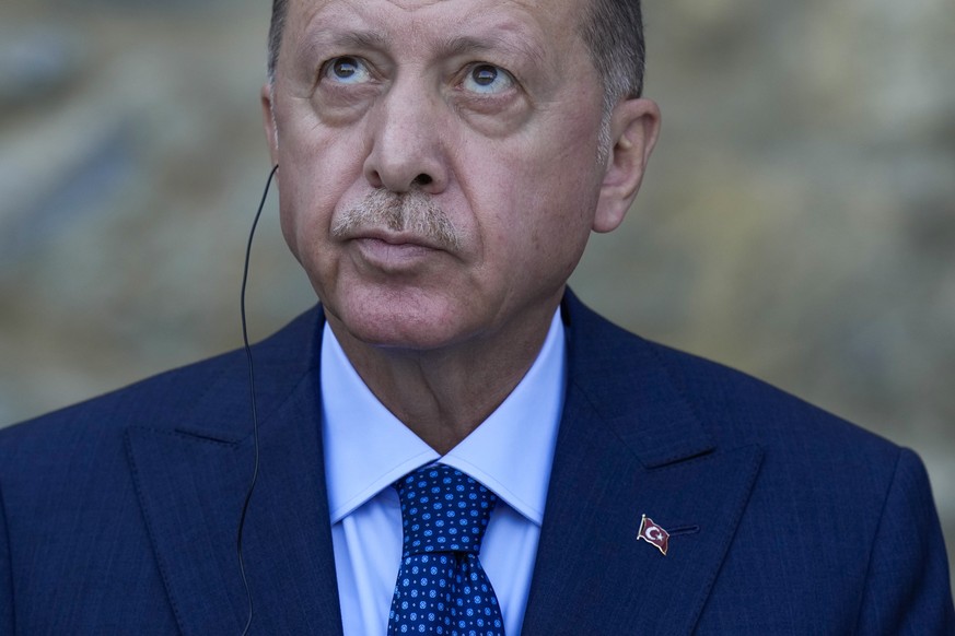 Turkey&#039;s President Recep Tayyip Erdogan looks up during a joint news conference with German Chancellor Angela Merkel following their meeting at Huber Villa presidential palace, in Istanbul, Turke ...