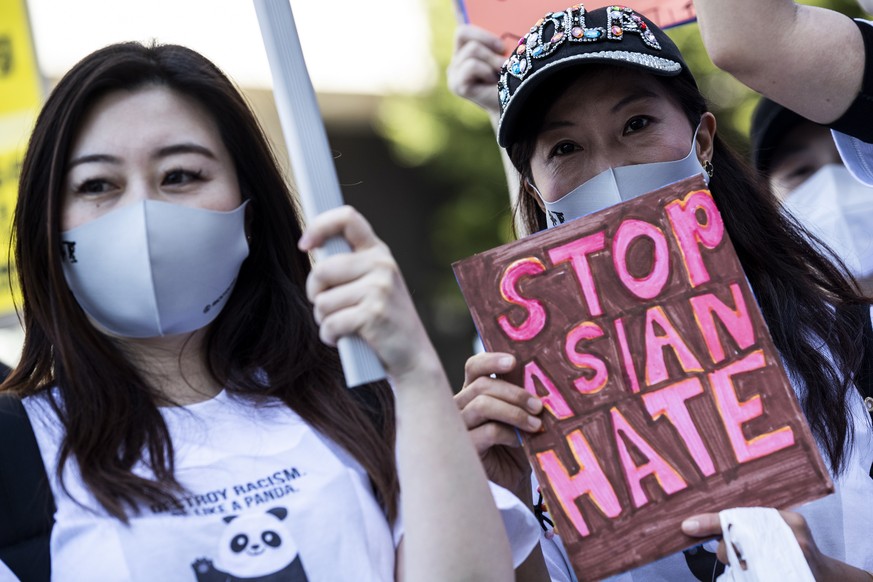 epa09102306 A demonstrator holds a poster reading &#039;Stop Asian Hate&#039; as hundreds of protesters gather during an Anti Asian Hate in Los Angeles, California, USA, 27 March 2021. This protest ag ...