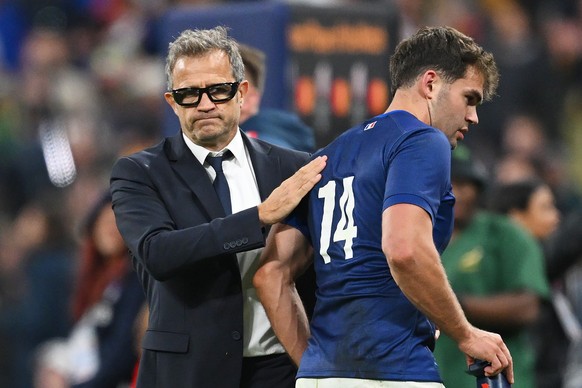 PARIS, FRANCE - OCTOBER 15: Fabien Galthie, Head Coach of France, consoles Damian Penaud of France at full-time after their team&#039;s loss in the Rugby World Cup France 2023 Quarter Final match betw ...
