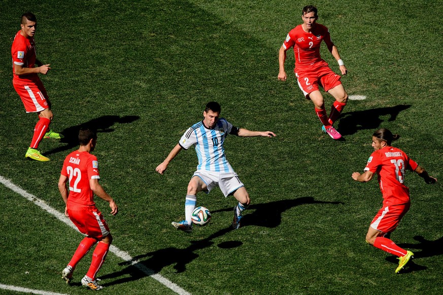 SAO PAULO, BRAZIL - JULY 01: Lionel Messi of Argentina controls the ball against Josip Drmic (L), Fabian Schar (2nd L), Stephan Lichtsteiner (2nd R) and Ricardo Rodriguez of Switzerland during the 201 ...