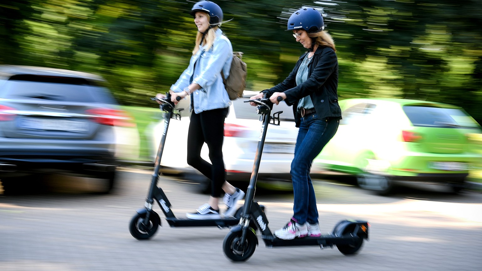 epa07627037 Women ride an CIRC e-scooter (former FLASH) in Herne, Germany, 05 June 2019. Even before electric pedal-scooters are allowed nationwide on 15 June, a first provider will start a rental ser ...