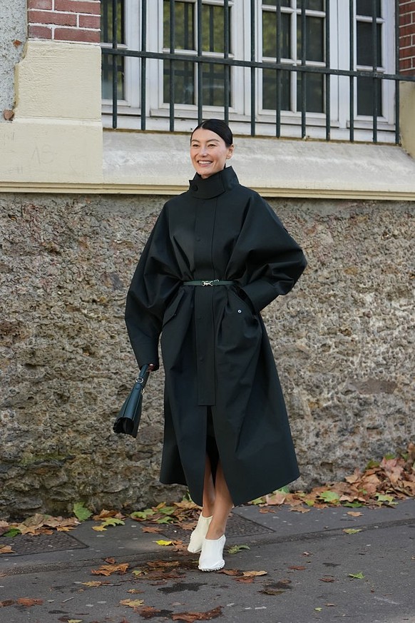 BERLIN, GERMANY - DECEMBER 10: Sonia Lyson is seen wearing black, oval-shaped Vehla sunglasses. Her outfit is cream-colored, consisting of a long, oversized faux fur coat that reaches her ankles. Unde ...