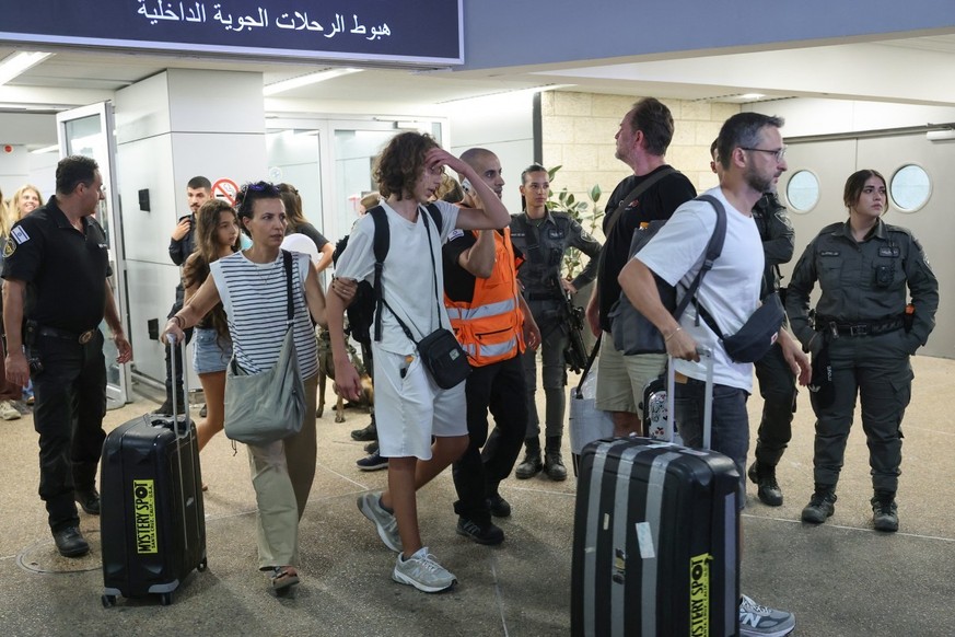 Passengers from an earlier diverted flydubai flight are seen after landing at Israel's Ben Gurion Airport in Lod on September 30, 2026. The flight, also operated by flydubai, landed on the tarmac ...