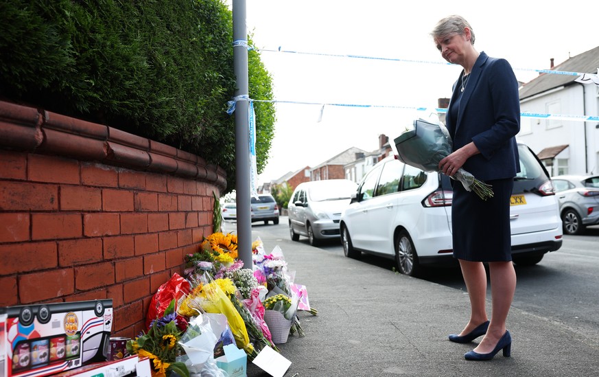 epa11508233 British Home Secretary Yvette Cooper lays flowers at the scene of a stabbing attack on Hart Street in Southport, Britain, 30 July 2024. Two children were killed and nine people were injure ...