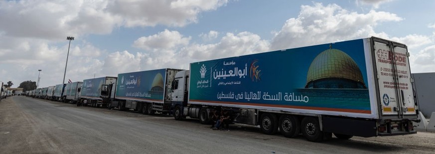 NORTH SINAI, EGYPT - OCTOBER 19: Aid convoy trucks wait at the Rafah border crossing for clearance to enter Gaza on October 19, 2023 in North Sinai, Egypt. The aid convoy, organized by a group of Egyp ...