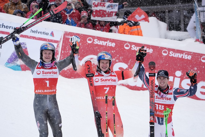 Switzerland's Marco Odermatt, center, winner of an alpine ski, men's World Cup giant slalom, poses with second placed Brazil's Lucas Pinheiro Braathen, left, and third placed France ...
