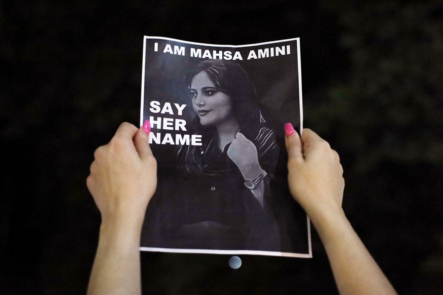 epa10206580 Protesters hold a vigil for 22-year-old Mahsa Amini at Sydney Town Hall, Australia, 25 September 2022. Protests have erupted in Iran and across the world after the death of Mahsa Amini who ...