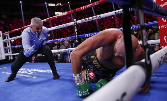 Referee Russell Mora counts to Tyson Fury, of England, after he was knocked down by Deontay Wilder in a heavyweight championship boxing match Saturday, Oct. 9, 2021, in Las Vegas. (AP Photo/Chase Stev ...