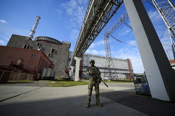 FILE - A Russian serviceman guards an area of the Zaporizhzhia Nuclear Power Station in territory under Russian military control, southeastern Ukraine, May 1, 2022. Ukrainians are once again anxious a ...