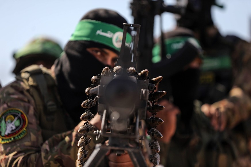 Israel-Gaza Conflict Palestinian fighters from the armed wing of Hamas are taking part in a military parade in front of an Israeli military site to mark the anniversary of the 2014 war with Israel, ne ...