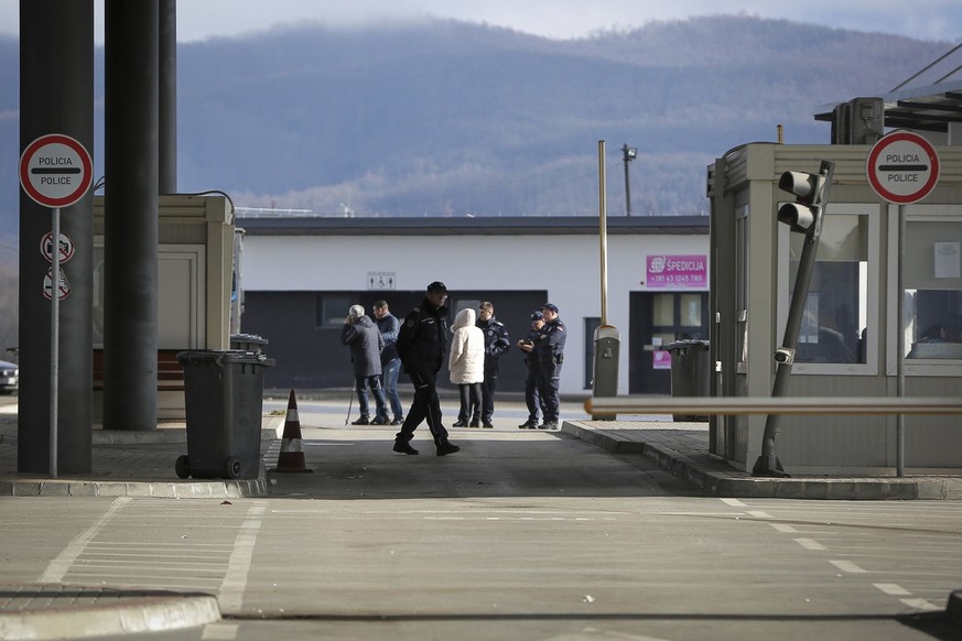 Serbian police officers stand at the closed Merdare border crossing between Kosovo and Serbia on Wednesday, Dec. 28, 2022. Kosovo closed the border crossing in Merdare, following an erected barricade  ...