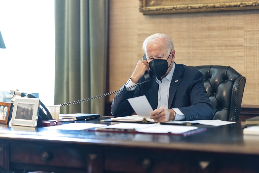 In this photo provided by The White House, President Joe Biden talks on the phone with his national security team from the Treaty Room in the residence of the White House in Washington, Friday, July 2 ...